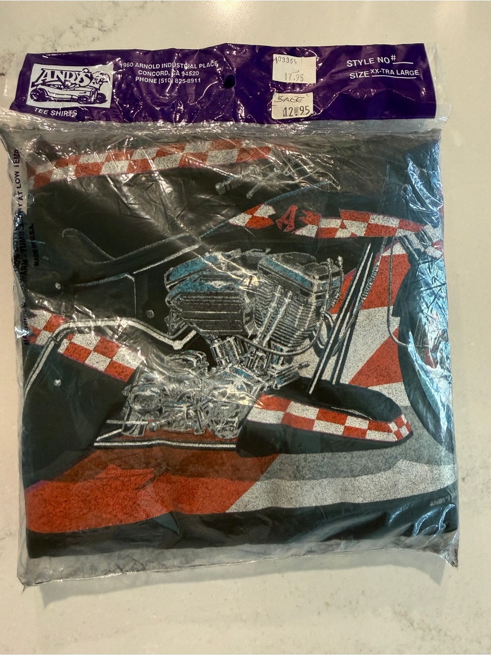Andy's Tee Shirt with Red & White Check Graphic. Possibly “Arlen Ness Team”?